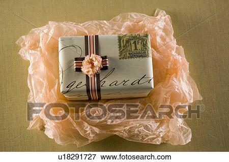 Gift being unwrapped View Large Photo Image Stock Photo - Gift being unwrapped. Fotosearch