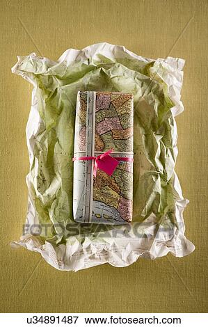 Stock Photo - Gift or present being unwrapped. Fotosearch