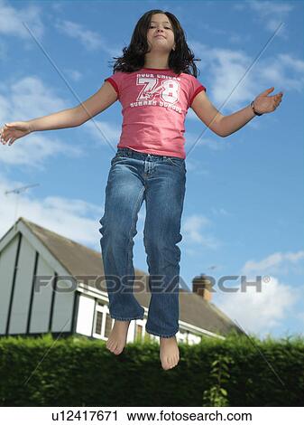 Girl, 10 on trampoline View Large Photo Image Stock Image - Girl, 10 on trampoline. Fotosearch
