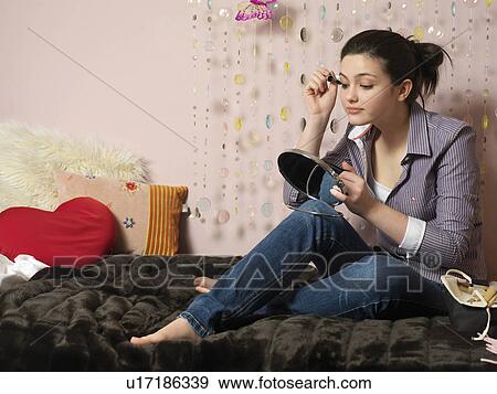 Girl, 14 applying make up View Large Photo Image Stock Photo - Girl, 14 applying make up. Fotosearch