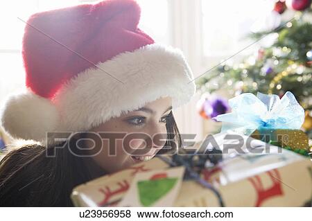 Girl, 14 looking at Christmas present View Large Photo Image Stock Photo - Girl, 14 looking at Christmas present. Fotosearch