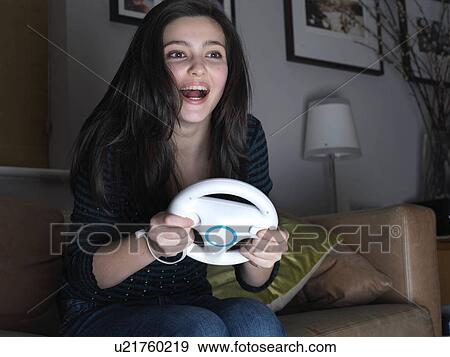 Girl, 14 playing driving game View Large Photo Image Stock Photo - Girl, 14 playing driving game. Fotosearch