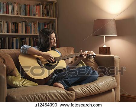 Stock Image - Girl, 14 playing guitar. Fotosearch