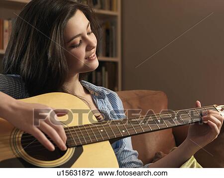 Girl, 14 playing guitar View Large Photo Image Stock Image - Girl, 14 playing guitar. Fotosearch