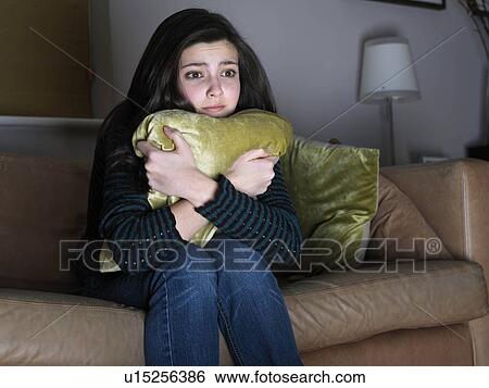 Girl, 14 watching sad movie View Large Photo Image Stock Photograph - Girl, 14 watching sad movie. Fotosearch