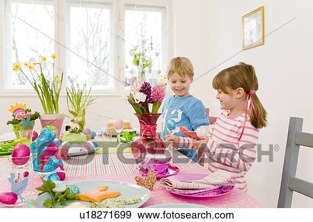 girl and boy admire easter table View Large Photo Image Stock Photo - girl and boy admire easter table. Fotosearch