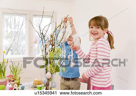 girl and boy decorate easter table View Large Photo Image Stock Image - girl and boy decorate easter table. Fotosearch