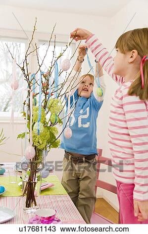 girl and boy decorate easter table View Large Photo Image Stock Image - girl and boy decorate easter table. Fotosearch