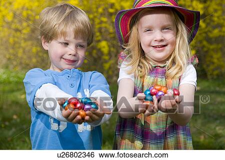 girl and boy holding easter eggs View Large Photo Image Stock Photograph - girl and boy holding easter eggs. Fotosearch