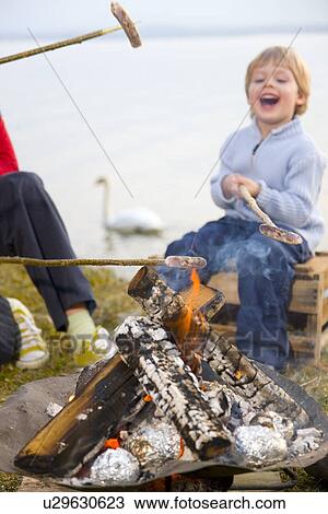 girl and boy roasting sausages on sticks View Large Photo Image Stock Image - girl and boy roasting sausages on sticks. Fotosearch