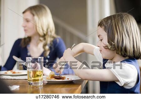 Stock Photograph - girl and younger sister eating. Fotosearch