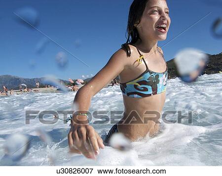 Stock Photo - Girl at Beach, swimming in the Sea. Fotosearch