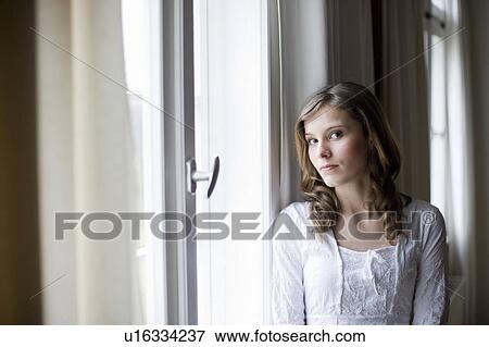 girl at window looking at viewer View Large Photo Image Stock Photo - girl at window looking at viewer. Fotosearch