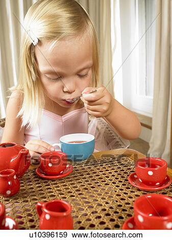 Stock Photo - Girl having a tea time. Fotosearch