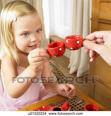 Girl having a tea time with her mother View Large Photo Image Picture - Girl having a tea time with her mother. Fotosearch