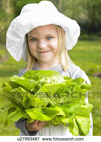 Girl holding a salad from the garden View Large Photo Image Stock Photo - Girl holding a salad from the garden. Fotosearch