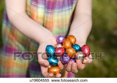 Stock Photography - girl holding easter eggs. Fotosearch
