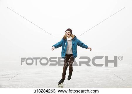 Girl iceskating on frozen lake View Large Photo Image Stock Image - Girl iceskating on frozen lake. Fotosearch