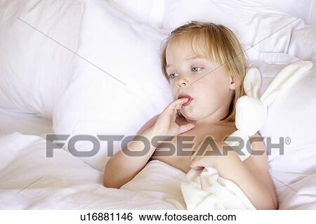 Girl in bed with her favorite plush View Large Photo Image Stock Photograph - Girl in bed with her favorite plush. Fotosearch