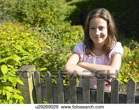 Stock Photo - Girl in her garden. Fotosearch