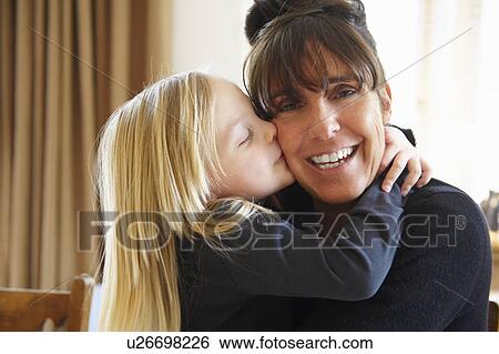 Girl kissing her grandmother View Large Photo Image Stock Photograph - Girl kissing her grandmother. Fotosearch