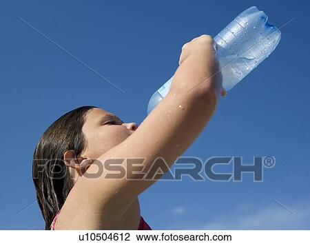 Stock Image - Girl laying on beach. Fotosearch