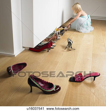 Girl lining up her mother's shoes View Large Photo Image Stock Image - Girl lining up her mother's shoes. Fotosearch