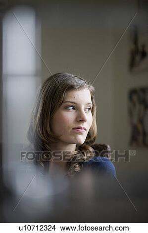 Picture - girl looking around a room. Fotosearch