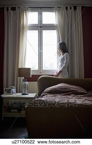 girl looking out of a window View Large Photo Image Stock Image - girl looking out of a window. Fotosearch
