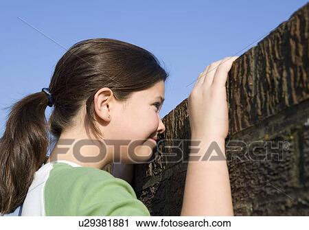 Girl looking over wall View Large Photo Image Stock Image - Girl looking over wall. Fotosearch