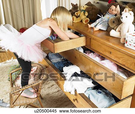 Girl looking through drawers View Large Photo Image Stock Photography - Girl looking through drawers. Fotosearch