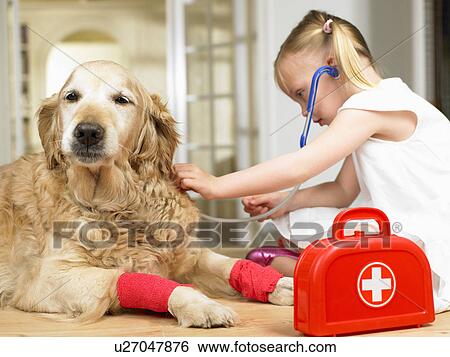 Stock Photograph - Girl playing doctor with dog. Fotosearch