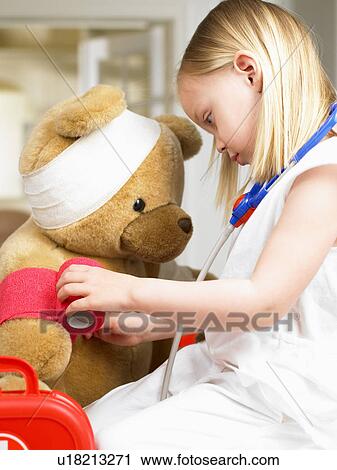 Girl playing doctor with teddy bear View Large Photo Image Stock Image - Girl playing doctor with teddy bear. Fotosearch