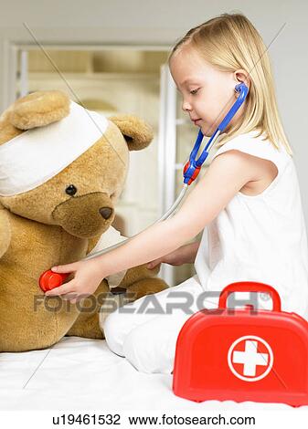 Girl playing doctor with teddy bear View Large Photo Image Stock Image - Girl playing doctor with teddy bear. Fotosearch