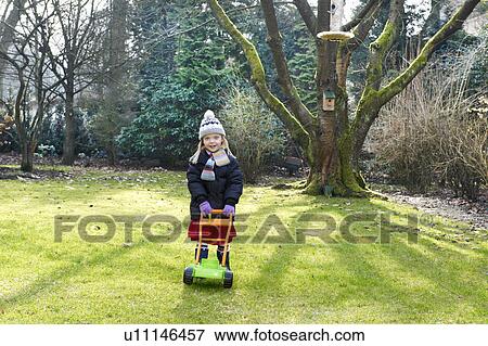 Girl playing in the garden View Large Photo Image Stock Photo - Girl playing in the garden. Fotosearch