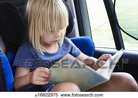 Girl reading in the car View Large Photo Image Stock Photography - Girl reading in the car. Fotosearch