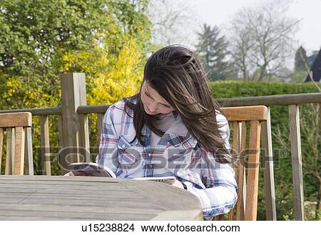 Girl reading outdoors View Large Photo Image Picture - Girl reading outdoors. Fotosearch