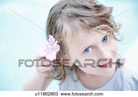 Girl with a flower in her hair View Large Photo Image Stock Image - Girl with a flower in her hair. Fotosearch