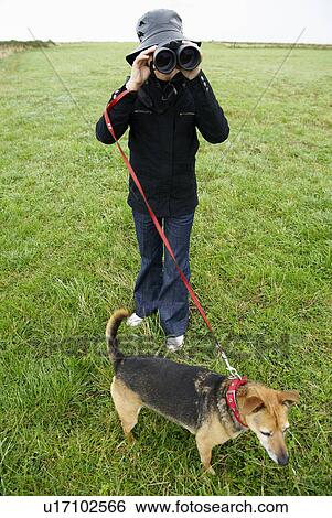 Girl with binoculars, walking the dog View Large Photo Image Stock Photograph - Girl with binoculars, walking the dog. Fotosearch