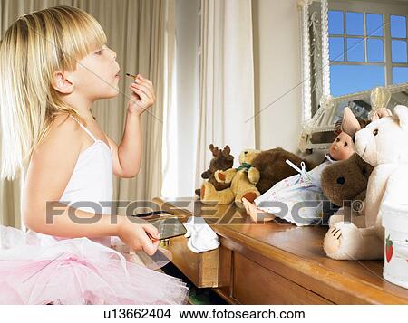 Picture - Girl with costume, putting on make up. Fotosearch