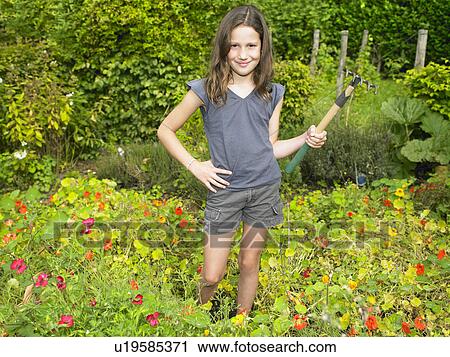 Girl working in her vegetable garden View Large Photo Image Stock Image - Girl working in her vegetable garden. Fotosearch