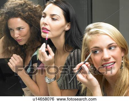 Girls applying makeup View Large Photo Image Stock Photograph - Girls applying makeup. Fotosearch