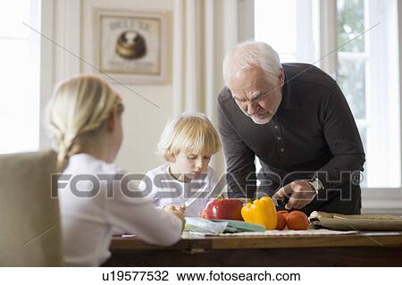 Stock Image - grandfather and grandchildren cooking. Fotosearch