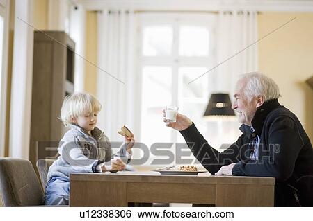 grandson and grandfather eating View Large Photo Image Stock Photograph - grandson and grandfather eating. Fotosearch