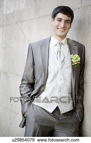 Stock Photo - Groom smiling at the camera.. Fotosearch