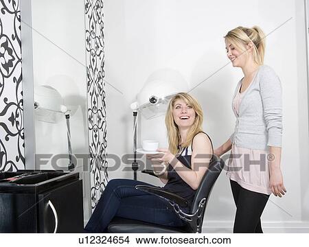 Hairdresser serving coffee to customer View Large Photo Image Picture - Hairdresser serving coffee to customer. Fotosearch