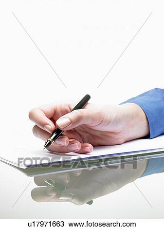 Stock Image - Hand of a woman, writing. Fotosearch