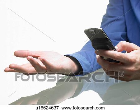 Stock Photo - Hands of a woman, holding cellular phone. Fotosearch