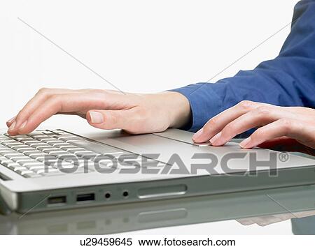 Stock Photography - Hands of a woman, on computer. Fotosearch