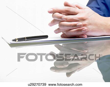 Stock Photo - Hands of a woman, resting from writing. Fotosearch